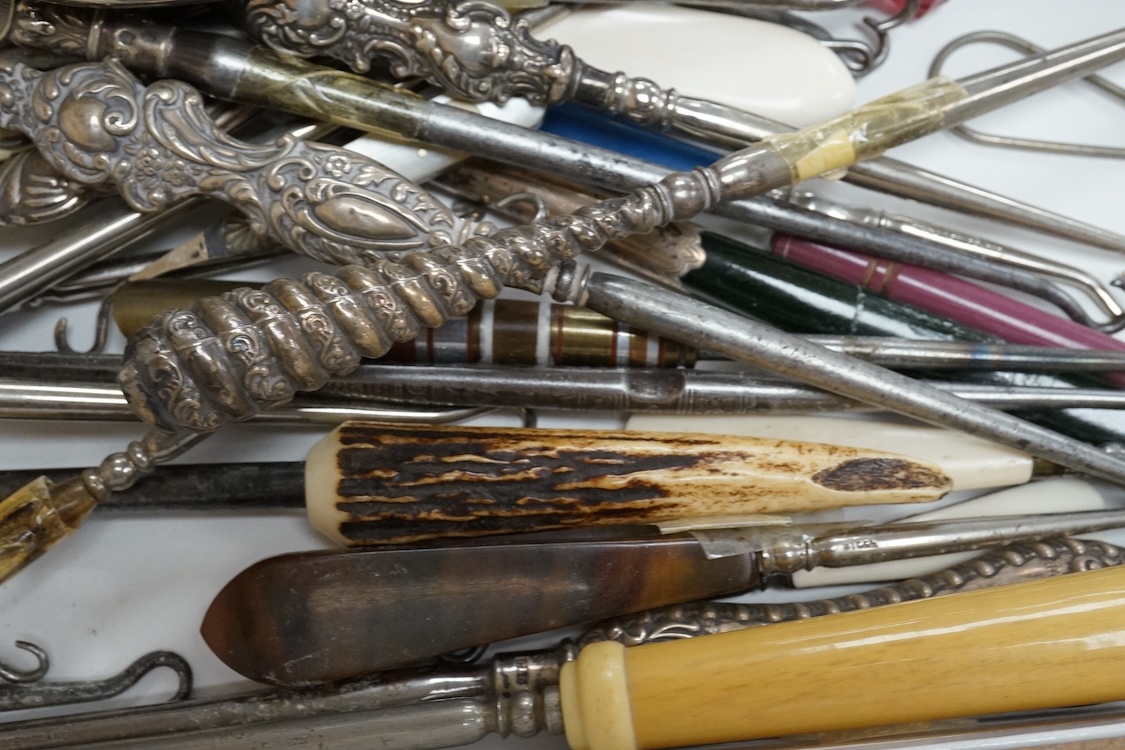 A large collection of Victorian button hooks, with silver, plate, mother of pearl and other handles